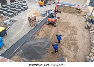 A Courtyard Is Paved With Paving Stones By A Civil Engineering Company With The Help Of An Excavator