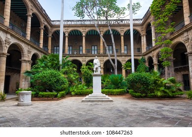 Courtyard of a spanish colonial palace in Havana with a statue of Christopher Columbus