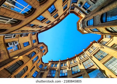 Courtyard well in old residential house from historical center of Saint Petersburg, Russia. Courtyard of well, view from below of the blue sky