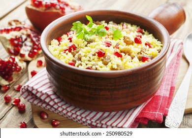 Couscous with pomegranate, raisins and spices on the table