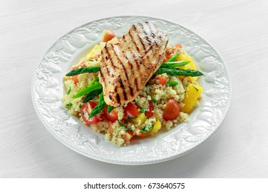 Couscous Salad With Grilled Chicken And Asparagus On White Plate. Wooden Table. Healthy Food