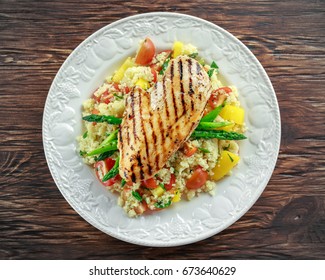 Couscous Salad With Grilled Chicken And Asparagus On White Plate. Wooden Rustic Table. Healthy Food