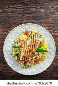 Couscous Salad With Grilled Chicken And Asparagus On White Plate. Wooden Rustic Table. Healthy Food