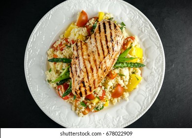 Couscous Salad With Grilled Chicken And Asparagus On White Plate. Stone Table. Healthy Food