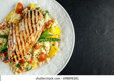 Couscous Salad With Grilled Chicken And Asparagus On White Plate. Stone Table. Healthy Food