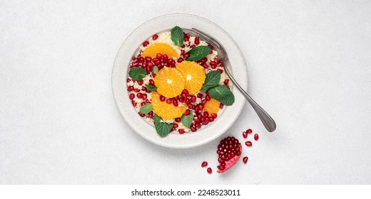 Couscous salad with oranges, pomegranate seeds and mint. Seasonal fruit salad. Middle eastern food - Powered by Shutterstock