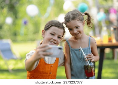 Cousins taking selfie at family garden party. Family reunion at a garden barbecue party. - Powered by Shutterstock