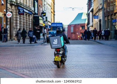 Coventry, UK - November 17, 2018: Deliveroo, Food Delivery Motor Bike Driver In Coventry City Centre,  Busiest Time Of The Day Evening For Delivery.