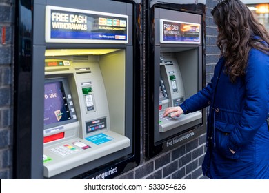 Coventry, UK - NOVEMBER 26, 2016: Young Adult Woman Withdrew Cash From ATM Machine