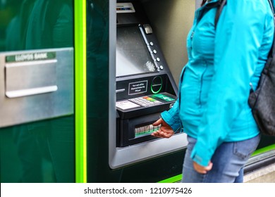 Coventry, UK - October 18, 2018: Young Adult Woman Withdrew From Cash Machine, Lloyds Bank ATM