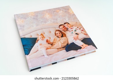 Cover Of Book With Photos Of Big Family At Home On A White Background. Photobook Is Gift. Professional Photographer And Designer. Printing Of Photos And Journals In Photo Laboratory