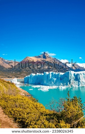 Cover page with big Perito Moreno glacier in Patagonia with blue sky and turquoise water glacial lagoon, South America, Argentina, in Autumn colors
