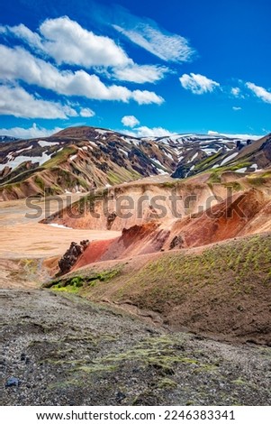 Cover page with colorful Icelandic rainbow volcanic Landmannalaugar mountains at famous Laugavegur hiking trail in Iceland, dramatic summer scenery, with blue sky and sunny day