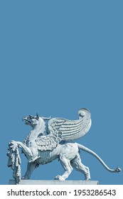 Cover Page Of An Old Statue Of Medieval Griffin, A Hybrid Of Lion And Bird, At Blue Sky Solid Background And Copy Space For Text In Dresden, Germany. Concept Historical And Religious Heritage.