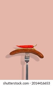 Cover Page With Single Grilled Sausage With Mustard On It And Hot Chili Pepper Put On A Metal Modern Fork At Solid Pink Color Background With Copy Space For Text. Concept Of Street Food And Cuisine