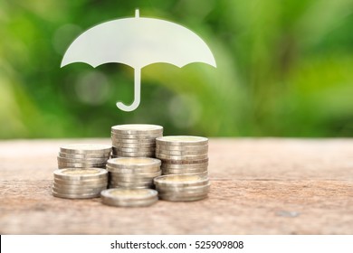 Coverage, Insurance Or Protection Concept, Stacks And Heaps Of Coins, Umbrella Nature Background