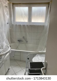 Covered Bathroom Walls With Tarp And Ladder In Preparation For Painting - House Renovation Concept