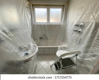 Covered Bathroom Walls With Tarp And Ladder In Preparation For Painting - House Renovation Concept