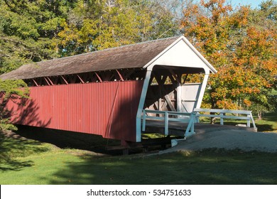 Covered Bridge in City Park Surrounded by Fall Foliage. Madison County, Iowa.
