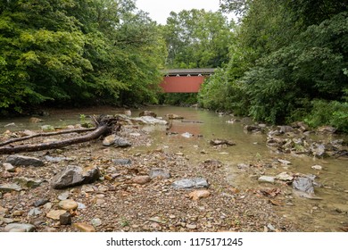 Covered bridge over a stoney stream