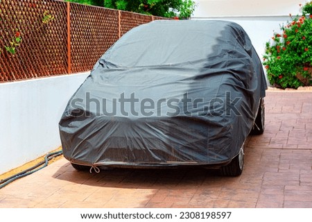 Covered car on a yard . Car Cover Carport Parking 
