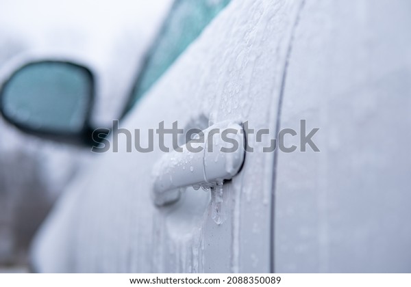 covered car Car side\
mirror covered with ice . Windshield Frozen car winter driving . .\
Frosty patterns on a completely headlights with icicles and snow in\
winter season scraping