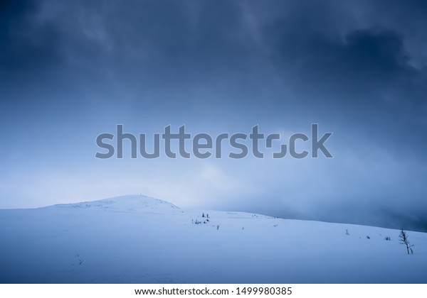 Covered in deep snow\
Storsteinen mountain summit and peak in the snow among the\
wonderful winter scenery,\
Norway