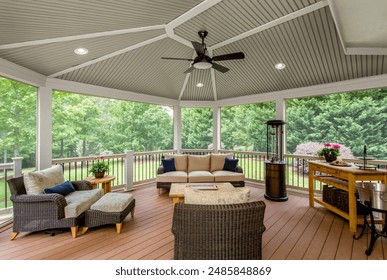 Covered Gazebo With Comfortable Seating And Ceiling Fan Amidst Green Lawn