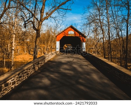 Covered Red Bridge over a stream