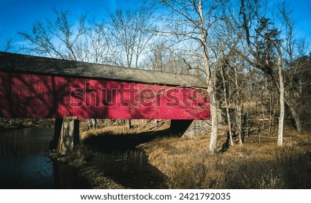 Covered Red Bridge over a stream
