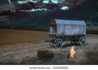 Covered wagon near Landquart in a thunderstorm atmosphere and campfire