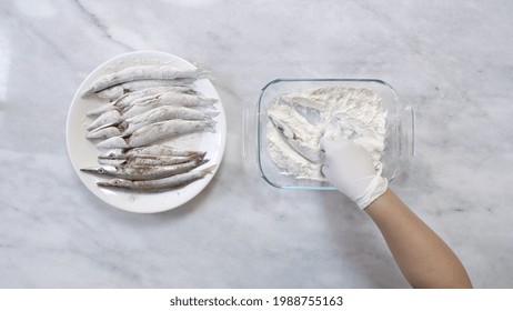 Covering Fresh Fish With Flour And Spices Before Roasting, Time Lapse. Top View