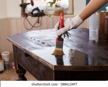 Covering Varnish Of Old Wooden Table. Restoration Of Furniture.