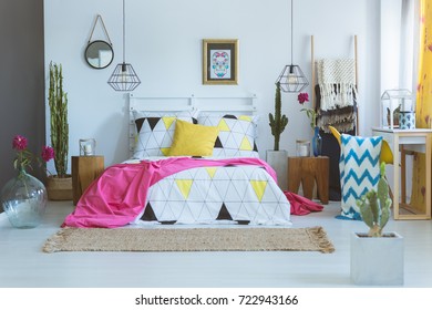 Coverlet With Geometric Pattern On King-size Bed In Unique Bedroom. Mexican Bedroom Concept 