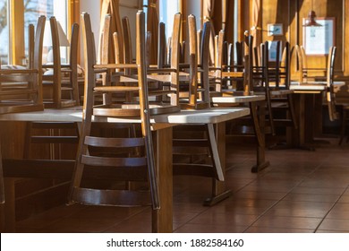 Covid 19 and closed restaurant with chairs on tables because of lockdown or shutdown. horizontal