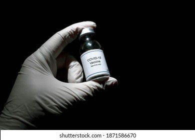 Covid 19 Corona Virus Ampoule Vaccine Cure In Doctor Scientist Hand Black Isolated Background