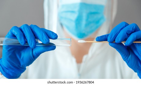 Covid 19 pcr test in nurse hands. Doctor in protective suit medical mask gloves holding Swab saliva sample for diagnostic covid19 coronavirus virus in lab. Nasopharyngeal culture pcr test. Web Banner.