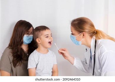 Covid 19 Test By Child. Doctor Or Nurse Testing Little Boy For Coronavirus Using Mouth Swab Method. Risk And Infection Control Concept. Health Of Children.