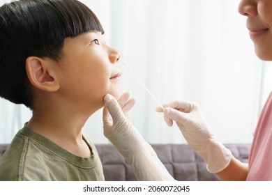 Covid 19 Testing Before Back To School Concept. An Asian Mom Gently Do A Nose Swab Test For Her Little Boy At Home. Living With Covid, Delta, Mu, New Normal, Student, Kids, Small, How To, Tested, Care