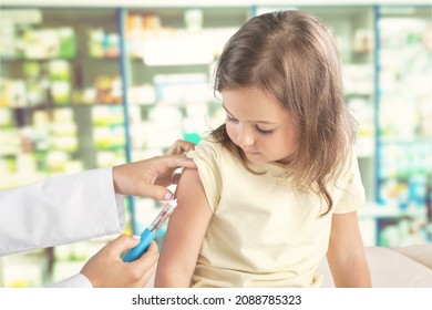 COVID 19 Vaccination For Kids Concept. Hands Of A Nurse Giving A First Dose Of Covid Vaccine In Hospital.