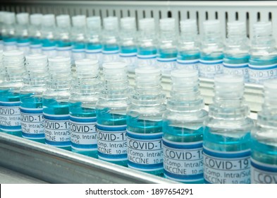 Covid 19 Vaccine Ampoules Line In Perspective .Two Lines Of Covid-19 Blue Vaccines In Some Lab Or Industrial Line Production.