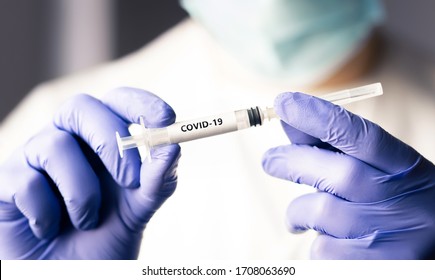 Covid 19 vaccine, immunity and medical treatment concept. Coronavirus syringe and needle. Doctor or nurse working in health care wearing a mask. Corona virus injection shot research. NCOV pandemic.