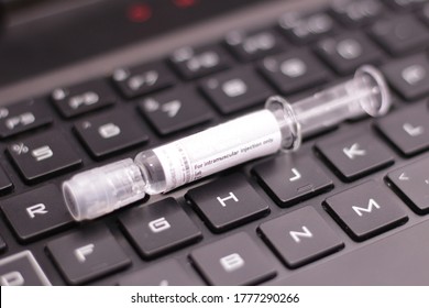 Covid 19 Vaccine Pre-filled Syringe SARS CoV 2 Sample On Keyboard Protein Folding Using Computer CPU And GPU