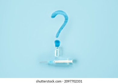 Covid 19 Vaccine Side Effects. Vaccine Storage And Handling. Spilled Medicine Vial Bottle, Question Mark And Syringe On Blue Background
