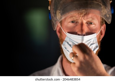 Covid Doctor And Health Care Worker, Putting On A Mask And Face Shield, While Wearing A Lab Coat And Gloves In Australia.