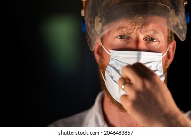 Covid Doctor And Health Care Worker, Putting On A Mask And Face Shield, While Wearing A Lab Coat And Gloves In Australia.