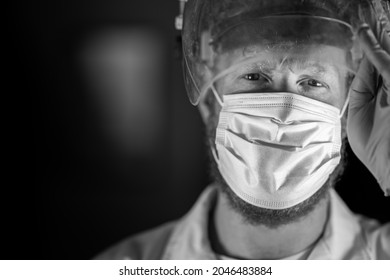 Covid Doctor And Health Care Worker, Putting On A Mask And Face Shield, While Wearing A Lab Coat And Gloves In Australia.