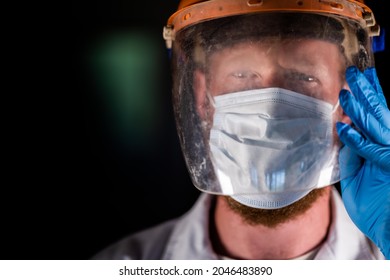 Covid Doctor And Health Care Worker, Putting On A Mask And Face Shield, While Wearing A Lab Coat And Gloves In Australia.