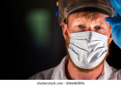 Covid Doctor And Health Care Worker, Putting On A Mask And Face Shield, While Wearing A Lab Coat And Gloves In Australia.