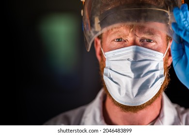 Covid Doctor And Health Care Worker, Putting On A Mask And Face Shield, While Wearing A Lab Coat And Gloves In Australia.